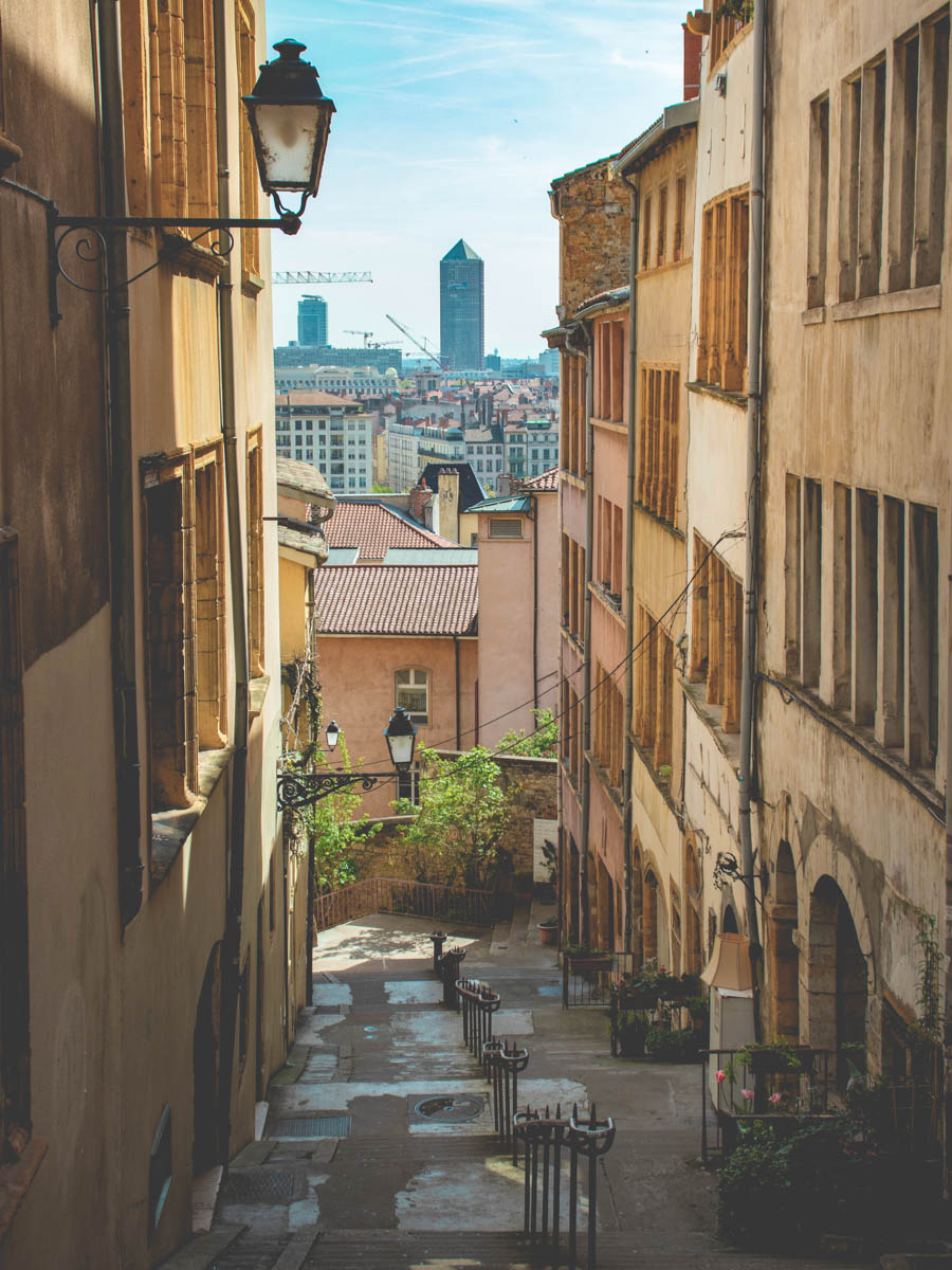 Picturesque-alley-in-Vieux-Lyon-France. Old beautiful street-lamps hagning from building.